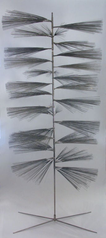 An early experimental work by Bertoia, as he investigated the influence of nature on his work. A simple cross base and stem, support a stack of 20 adjustable stainless spray branches, each composed of four carpenters nails with its own array of thin