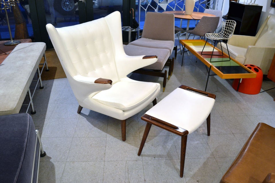 Two Papa Bear chairs with ottomans by Hans Wegner.<br />
Manufactured by AP Stolen, 1950's.<br />
Brilliantly reupholstered in white leather.