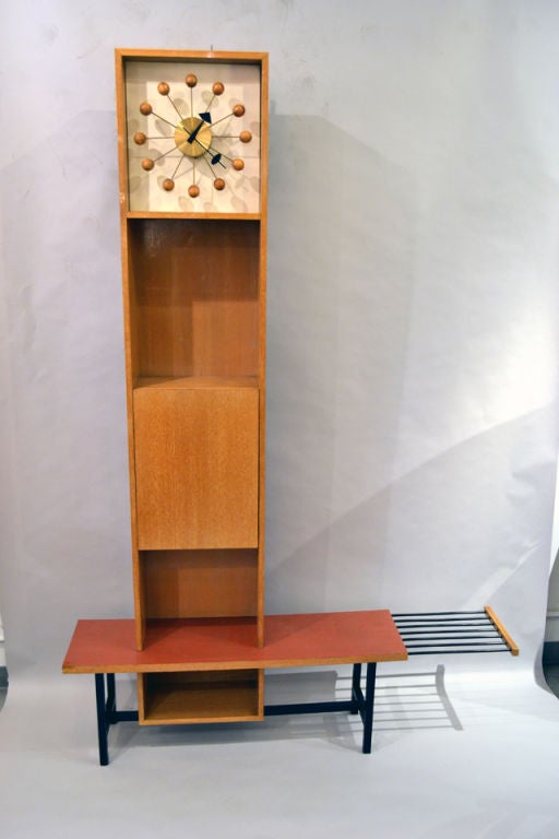 A very rare custom unit made by Herman Miller. The storage case sports a Nelson clock within the center section, an enclosed cubby, and a rack plank. A very unusual and artistic design.