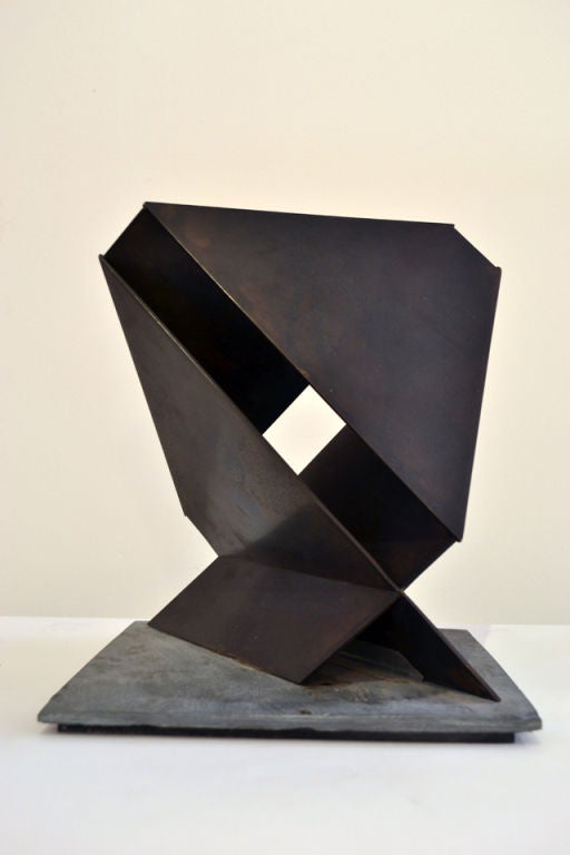 A geometric Helix form constructed of Bronze and mounted on a slate base. The form is very reminiscent of Tony Smith's sculptural works and is rooted in the Minimalist tradition. It is possible that this maquette is the artist's model with the