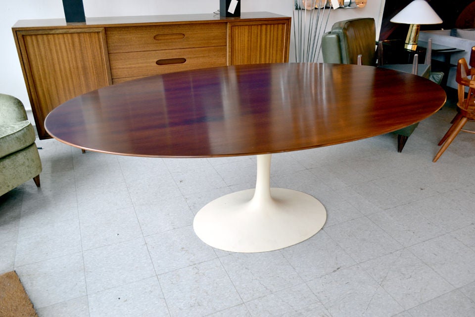 An icon of design from the Modern era, designed by Eero Saarinen and Manufactured by Knoll. The top is walnut veneer and rests on a cast iron tulip base.