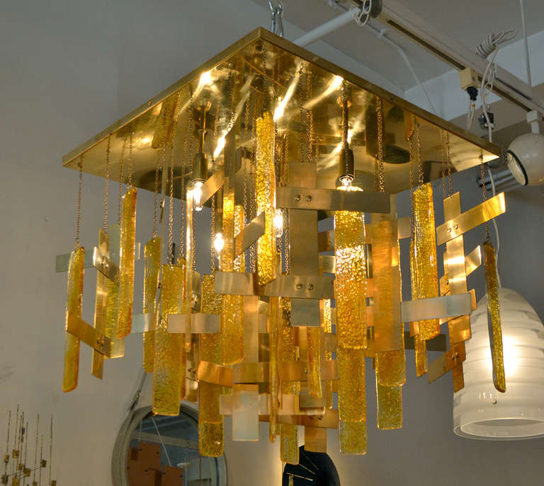 A wonderfully glitzy ceiling mount chandelier with amber glass and brass hanging embellishments by Sciolari, Italy.