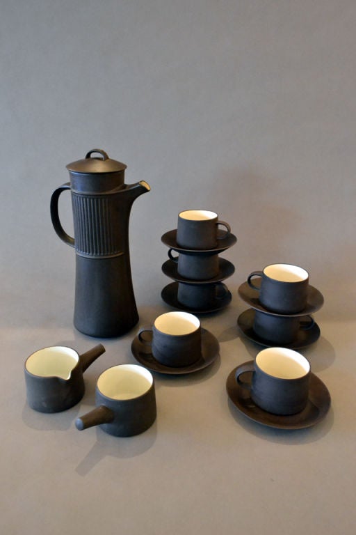 A wonderful set of coffee service pottery ware by Dansk. The set includes a total of seven cups with saucers,one creamer and one sugarbowl, and one carafe. Each piece stamped made in Denmark, Dansk.