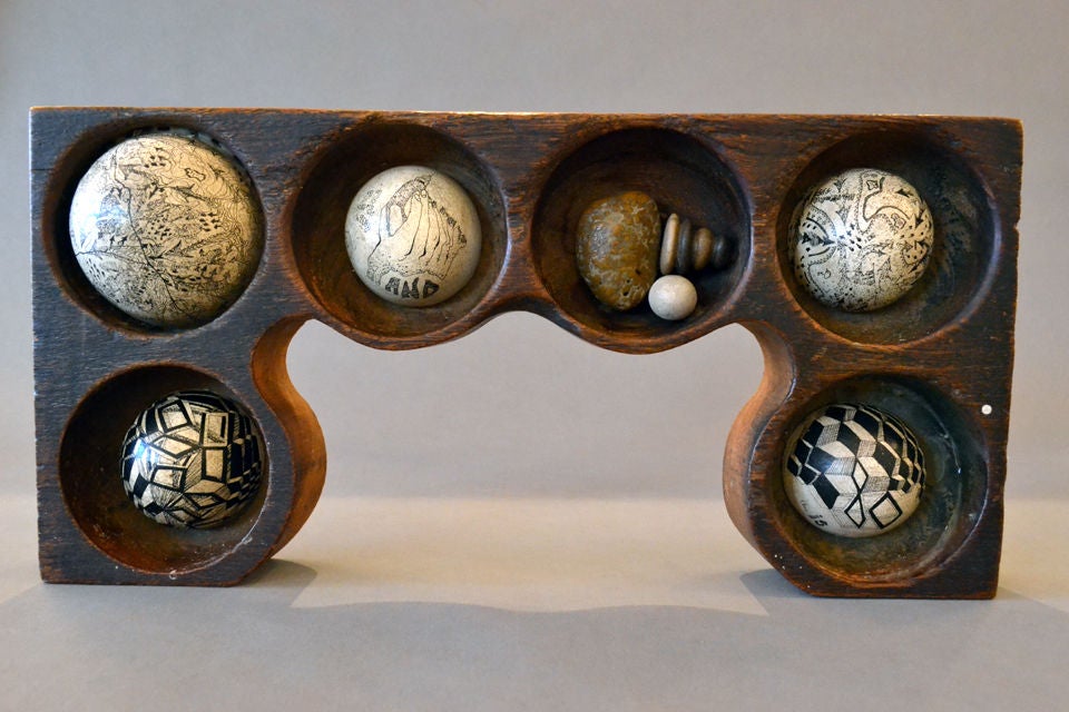A unique and rare assemblage by artist, Mary Bauermeister. Each half-sphere contains miniscule drawings and poetic visual verse.