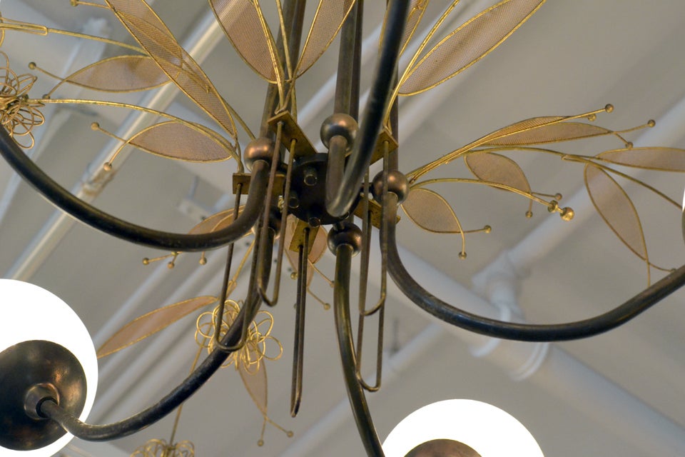 A lovely mid-century chandelier designed by Paavo Tynell for Lightolier. Paavo Tynell worked in NY for Lightolier from 1958-64.   The brass structure is decorated with branch ornaments and flowering clusters.