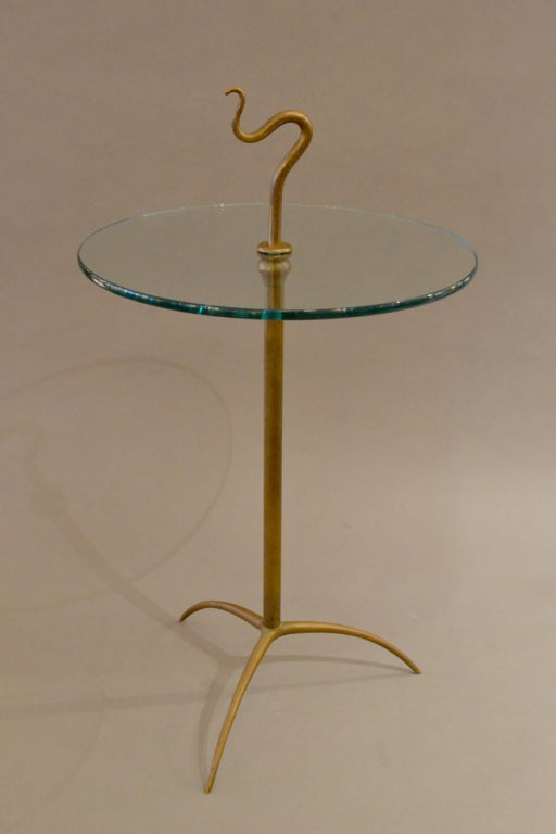 A fine example of postwar Italian design.  This is truly the hand of an Italian master.
The brass tripod and the whimsical finial are beautifully aged.