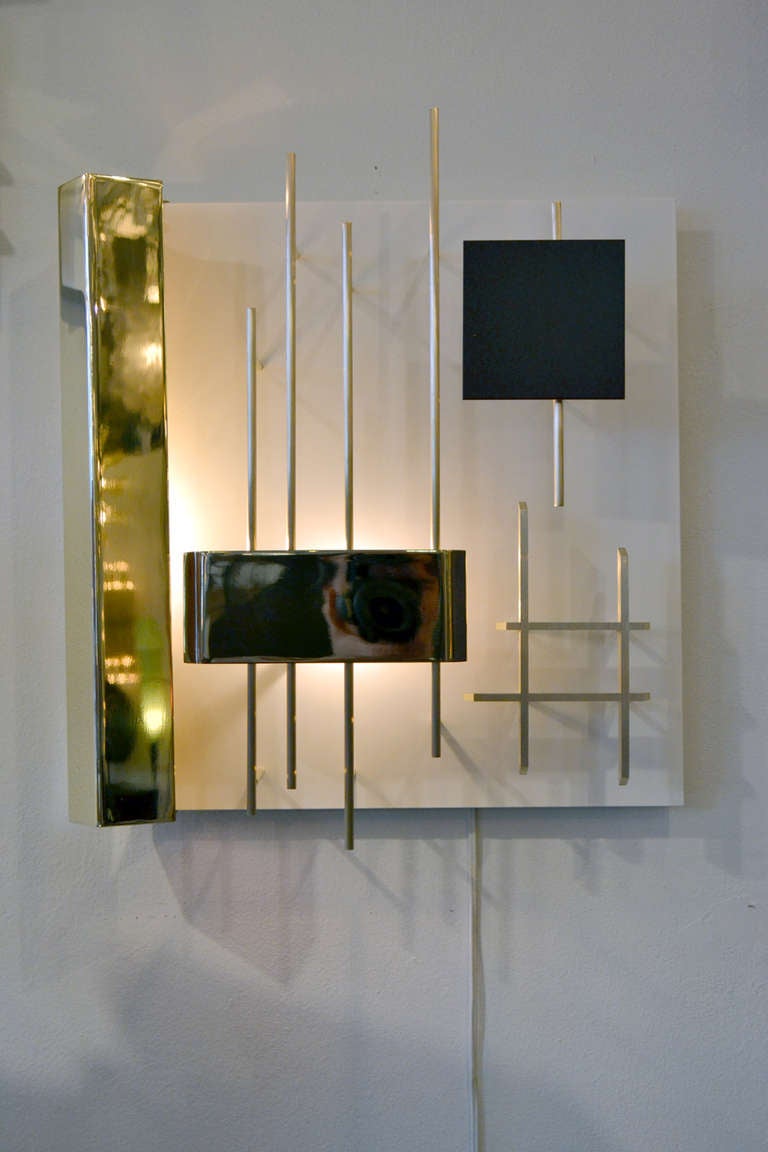 A wonderful pair of sconces by Gio Ponti for Lumi lighting, Italy. The sconces take on a constructivist and geometric form within themselves.