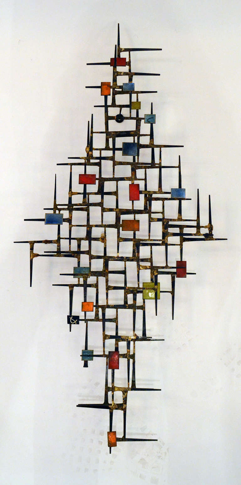 A wonderful Nail Art wall sculpture with color enameled panels. The work is reminiscent of artist such as Harry Bertoia and other decorative sculpture artists form the Mid Century Era.