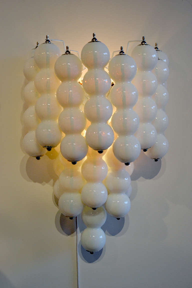 A very stylish and unique pair of sconces of Murano glass. The sconces consist of layed glass cylinders.