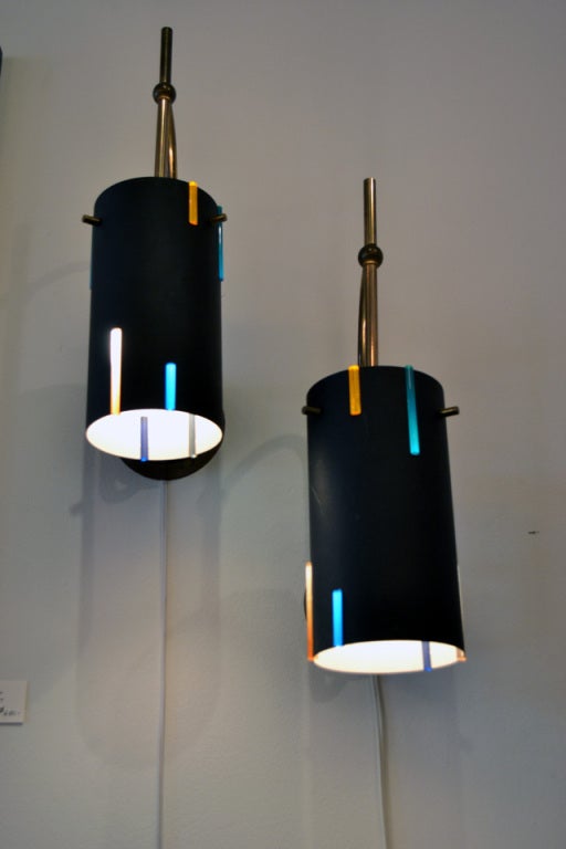 A wonderful and playful pair of wall sconces manufactured by Lightolier. Each light cylinder has colored lucite accents for added character and ambience.