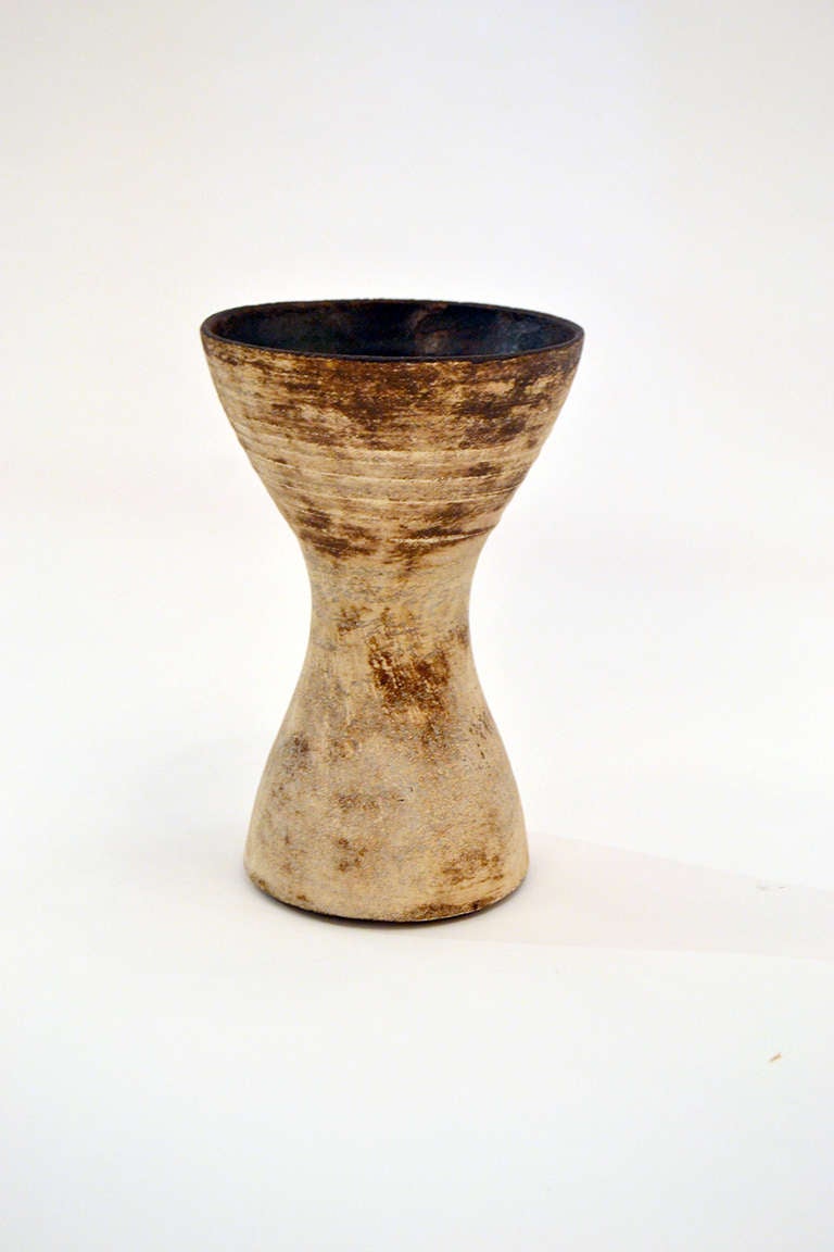 A wonderfully rare fluted vase by the remarkable British ceramicist, Hans Coper. The vase is made of  a white stoneware clay with iron oxide wash in the inside and lightly applied to the outside walls to enhance the overall texture.