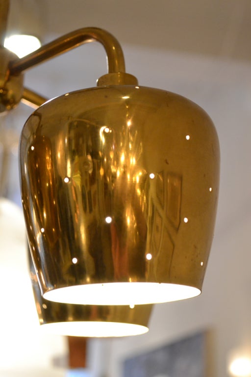 A wonderful petite ceiling fixture in brass, in the manner of Paavo Tynell. The fixture is small in scale and would be best suited for vestibule/ entry hall.