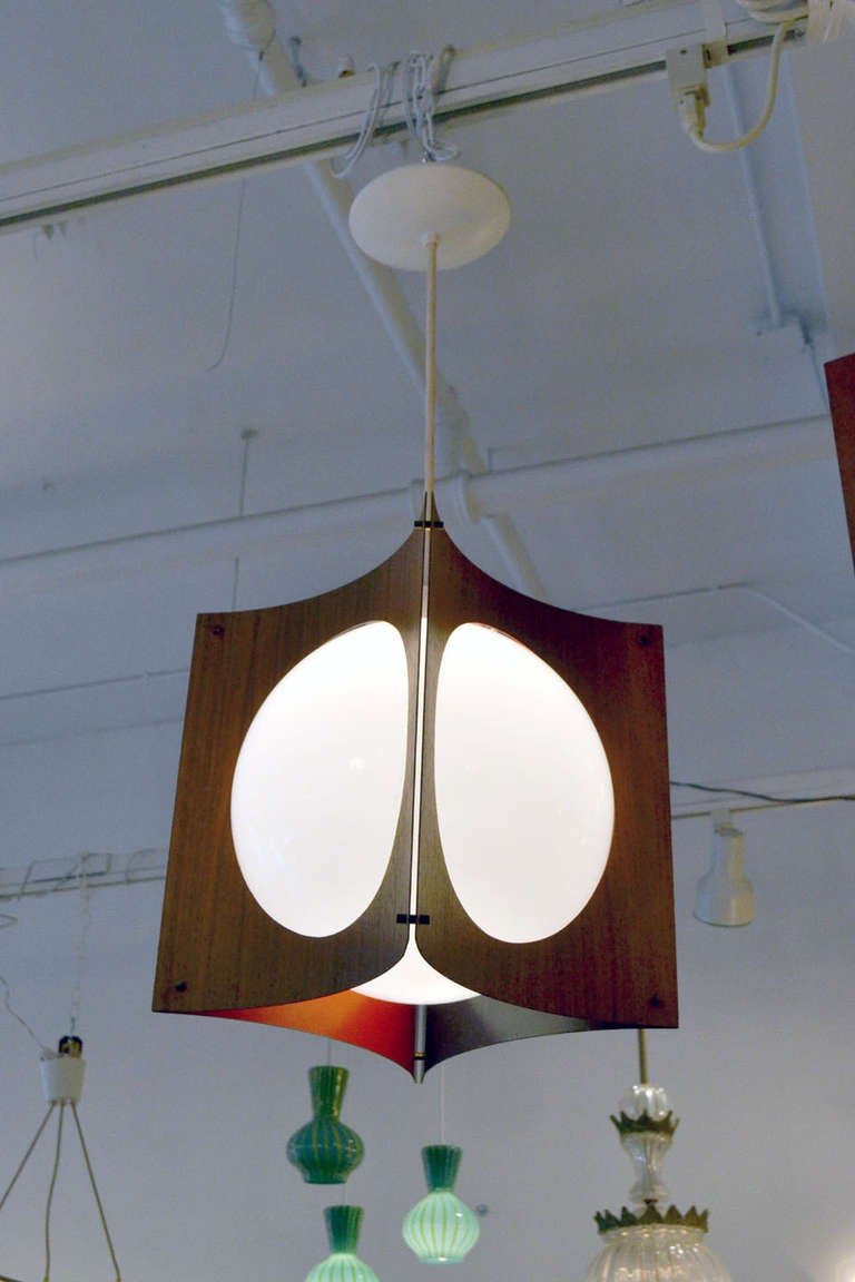 An unusual globe pendant with California Modern Style. The globe is encased by four panels of veneered wood and metal slats. The measurements are for the fixture itself, the cord length is adjustable.