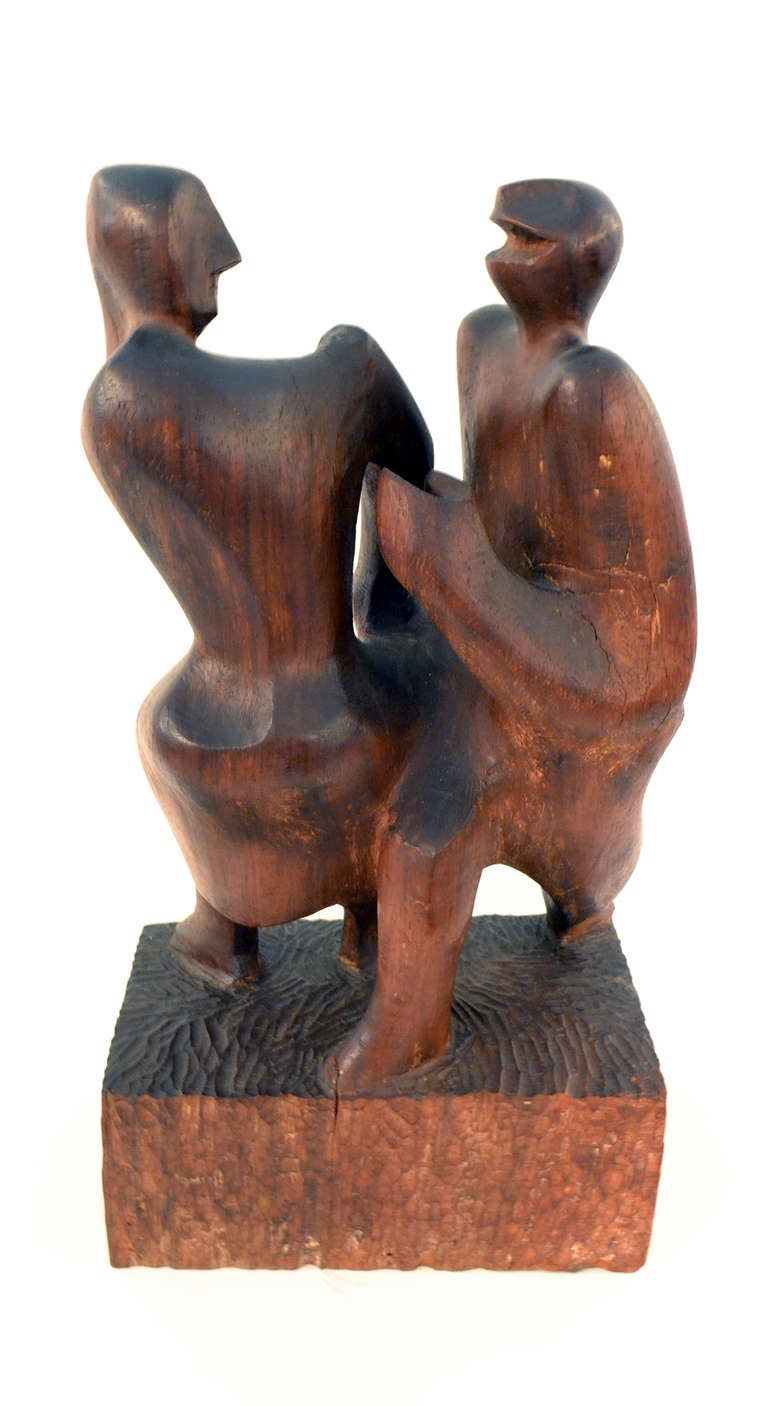 A wonderfully hand-carved block sculpture of a couple dancing. The sculpture is reminiscent of folk carving and WPA styles.