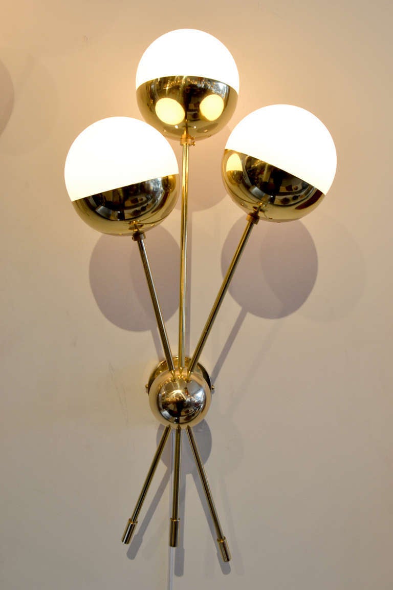 A wonderful pair of Sputnik style sconces. These sconces are a modern day reproduction in the manner of Stilnovo lighting, Italy.