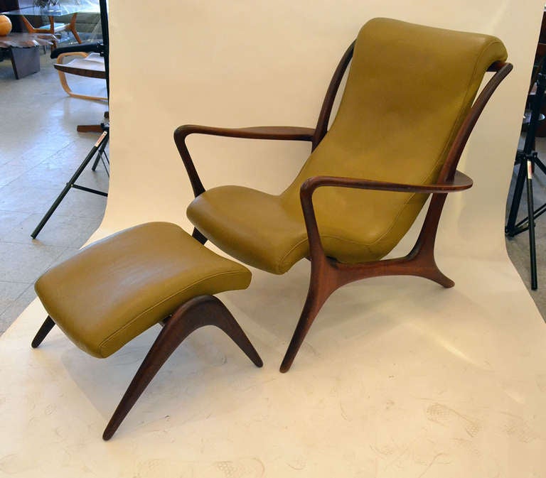 A wonderfully carved and sculpted walnut lounge chair and ottoman by Vladimir Kagan. The chair's fine curved frame supports a body contoured sling like seat. 