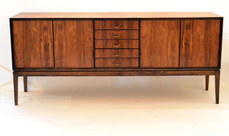 This is simply a beautiful piece of furniture with unusually active rosewood graining.  It has classic lines and incredibly functional storage capacity.