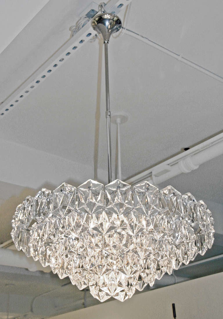 This elegant chandelier has beautifully faceted cut glass elements that create a glistening effect.