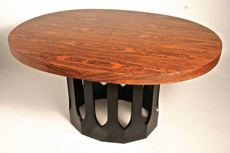 This table is a classic Harvey Probber design with his signature Gothic arched base. Although it is missing the leaves the matched grain rosewood top is so beautiful it works wonderfully as a small dining table in it's present form.