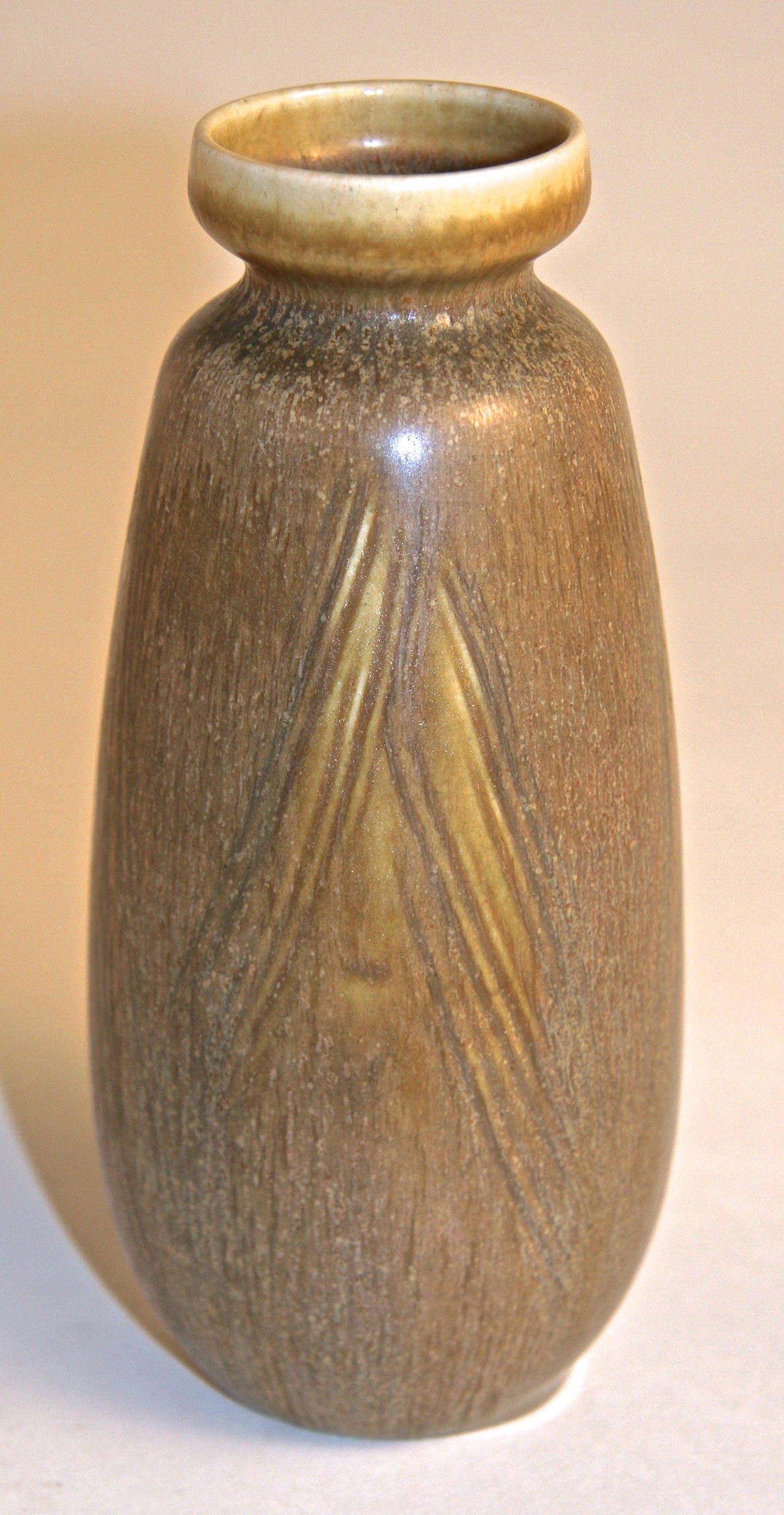 Stoneware vase with pale brown glaze and impressed diagonal lines to body.
Impressed 