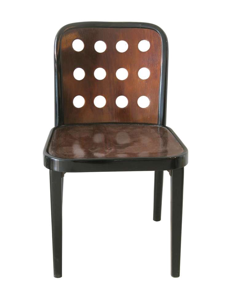 4 Vienna Secession chairs, # 811, in ebonized and walnut stained beech wood with perforated back by Josef Hoffmann, produced by Thonet, Austria, ca. 1930.
The chairs were exhibited for the first time by the Österreichischer Werkbund at the