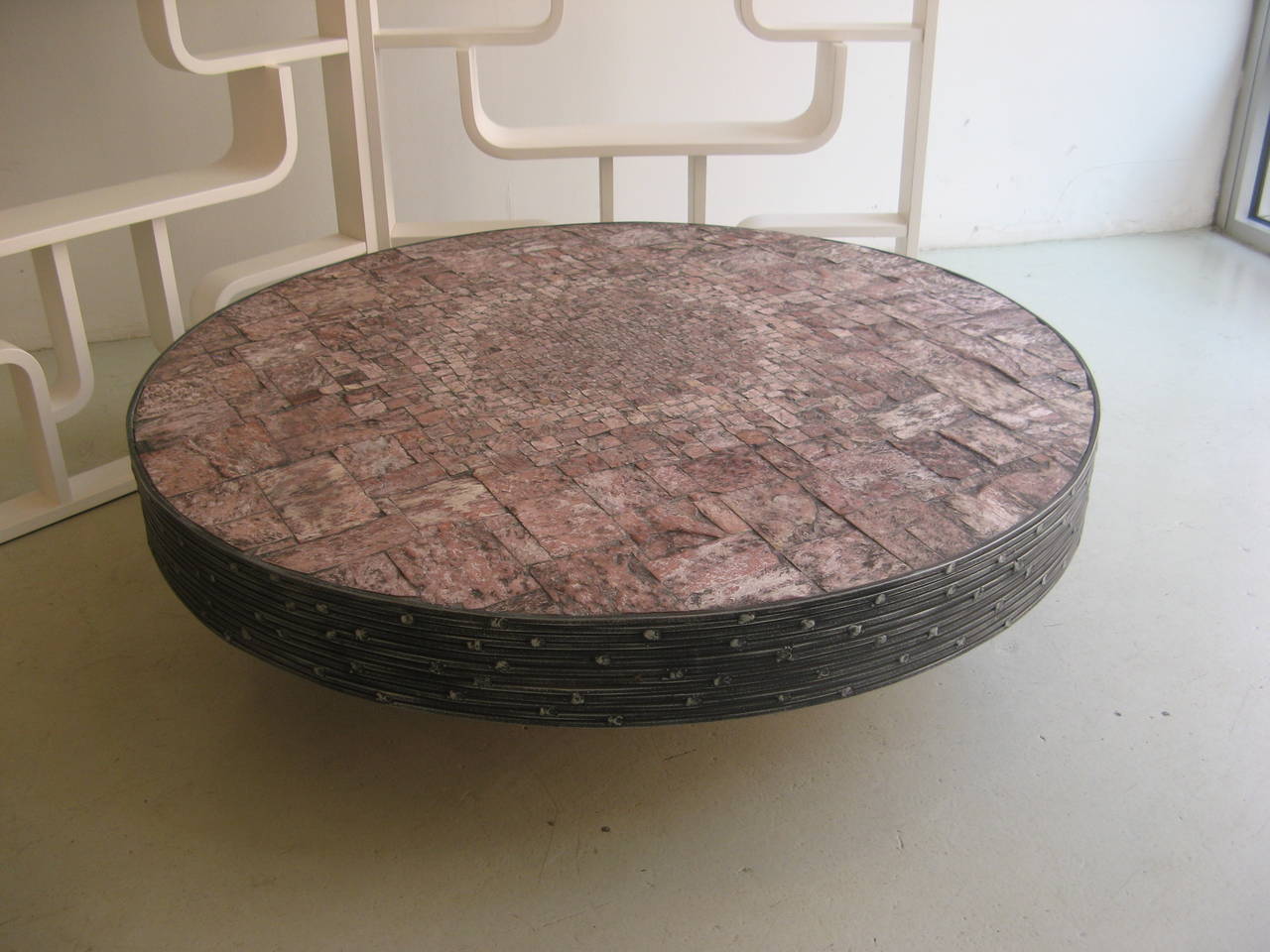 Coffee table with wrought iron openwork frame with asymmetric welds on a support and square base. The top is inset with a mosaic of warm palette stones and comes with maker's plaque by Pia Manu, Italy, circa 1965.