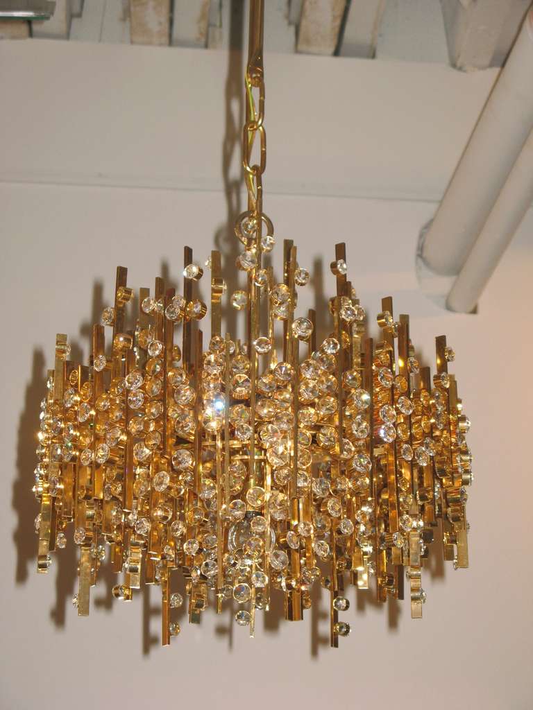 Mid-Century gold-plated brass pendant/chandelier with hundreds of Austrian crystals by Lobmeyr, Austria, circa 1960.

Newly electrified with five candelabra sockets and canopy.