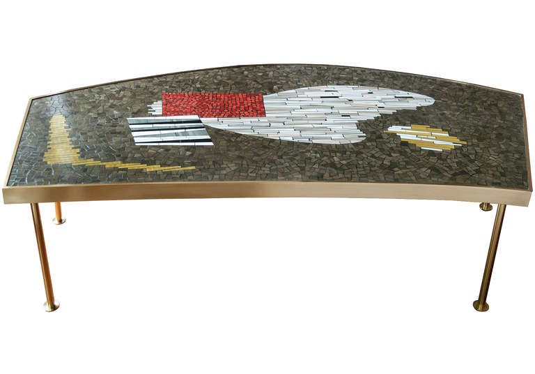 Large and impressive mid - century coffee table with colorful ceramic mosaic top, with a polished brass frame and the top is supported by 4 cylindrical legs, Austrian, c. 1950.
Paper label 