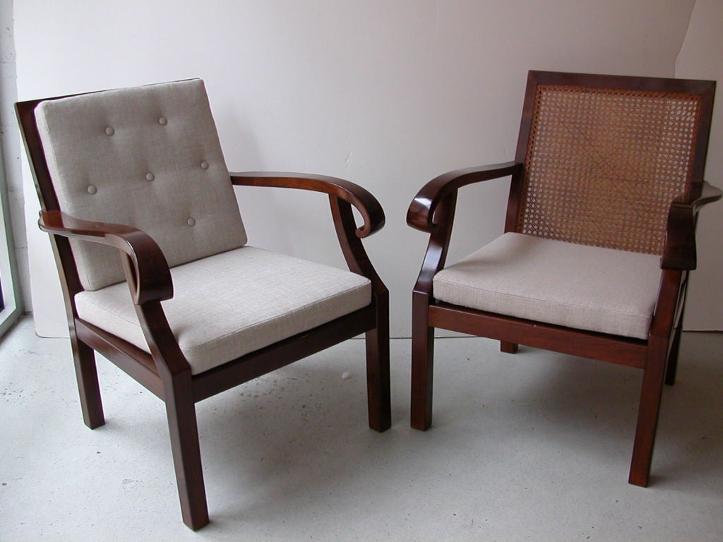 Pair of Austrian Art Deco armchairs in mahogany stained wood with scrolled arms, caned back and seat and back cushions, circa 1930.