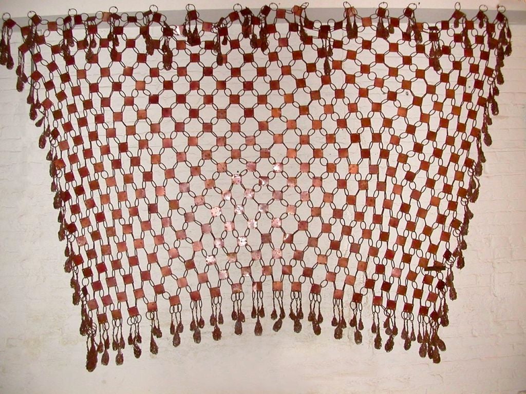 Unique wall hanging in copper treated metal with decorative tassels on four sides, Brazil, circa 1980. Signed.

This decorative piece could also be used as a room divider.