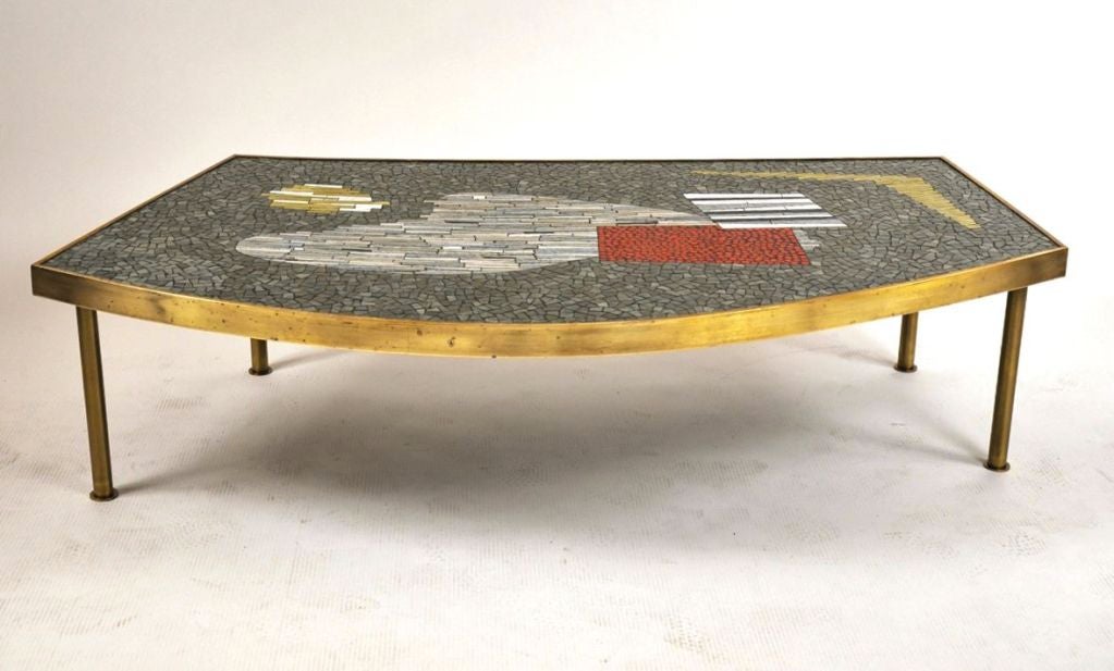 Curved colorful mosaic tile coffee table with thick brass frame supported on four cylindrical legs with circular feet, Italy, c. 1950.