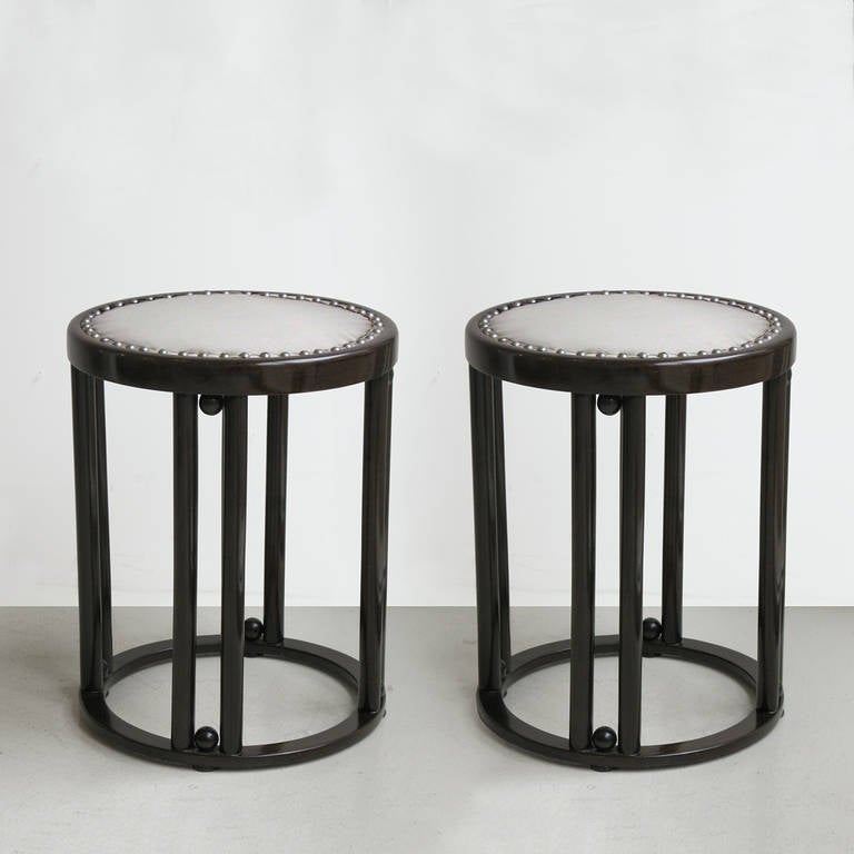 Pair of Vienna Secession stools in dark mahogany stained beechwood with grey silk upholstery by Josef Hoffmann, produced by J. & J. Kohn, circa 1905. 
Kohn label under seat.
Restored.