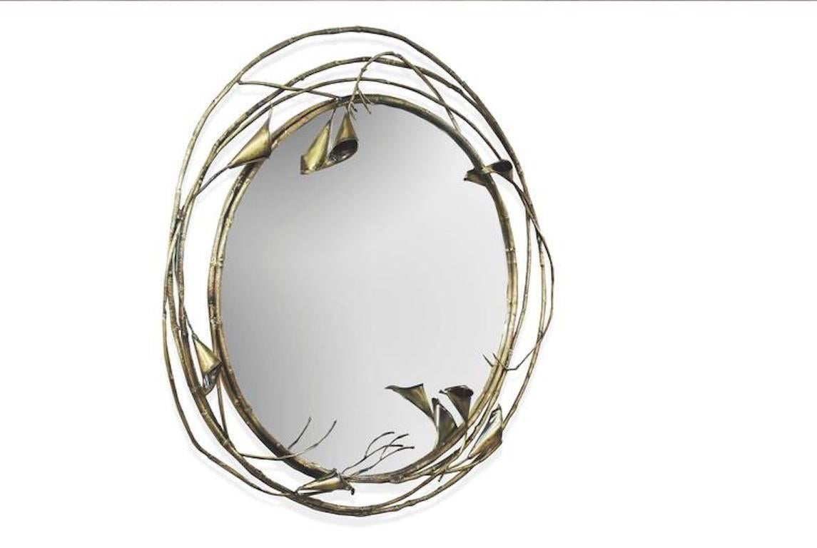 Cherish the beauty of every passing glance or intimate encounter with the flawless mirrored glass and exotic floral frame of the Stella. Fanciful stems and ethereal antique brass calla lilies create a charmed halo around anything that is captured by