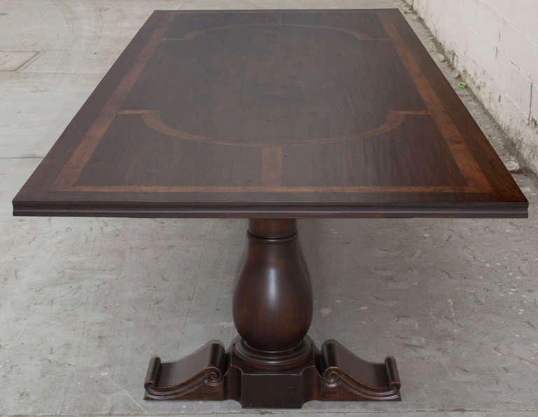 This massive banquet table is very impressive, made in solid walnut with inlaid tiger maple. This table captures the feel of the Renaissance with its superb hand-carved legs, inlaid pattern and molded edges. The sturdy extension mechanism allows the
