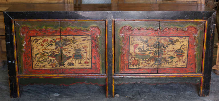 Mongolian sideboard or server with original lacquered floral designs on doors with decorative scalloping.