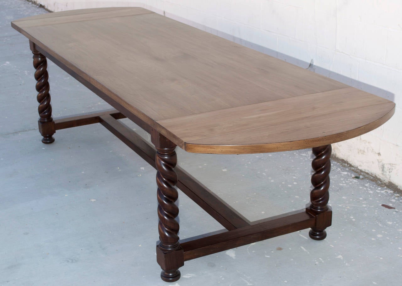 This custom dining table has barley twist legs made from reclaimed walnut. The base has a darker finish and the top is bleached with satin lacquer finish. The barley twist legs are masterfully hand-carved to perfect mirror image spirals.

As shown,