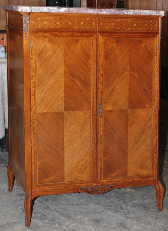 A very well made cabinet with nicely inlaid wood.