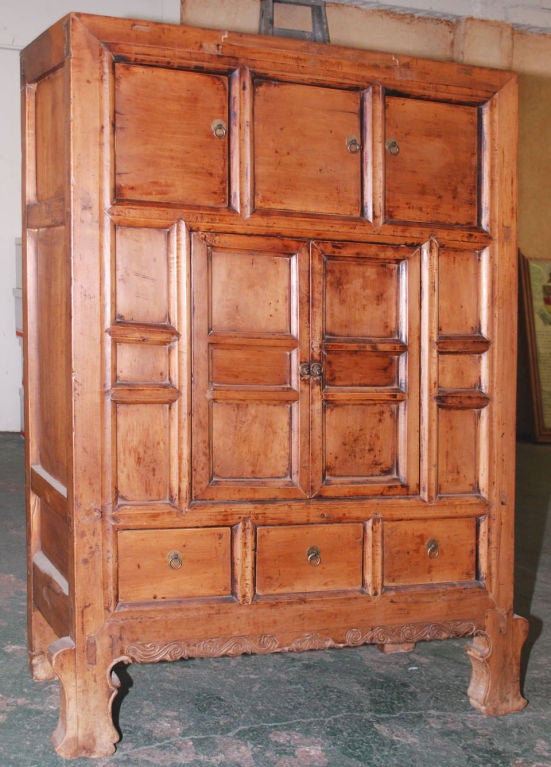 Very solid and well-built hutch with three doors above, a center cabinet with two doors and three drawers below. Note the delicate carvings on the feet and apron.