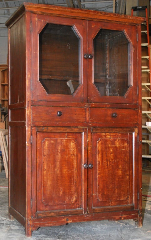 Early 20th century cabinet with two glazed doors above, two drawers and two doors below with solid, raised, panels. Nicely made with through-tenon construction. Great patina.