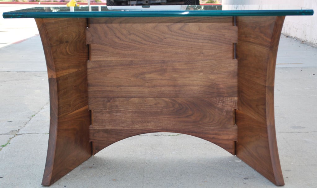 This desk is made from three walnut panels connected by two wooden hinges allowing the desk to alter shape, it can even lay flat for transport. Here it is shown with a 3/4
