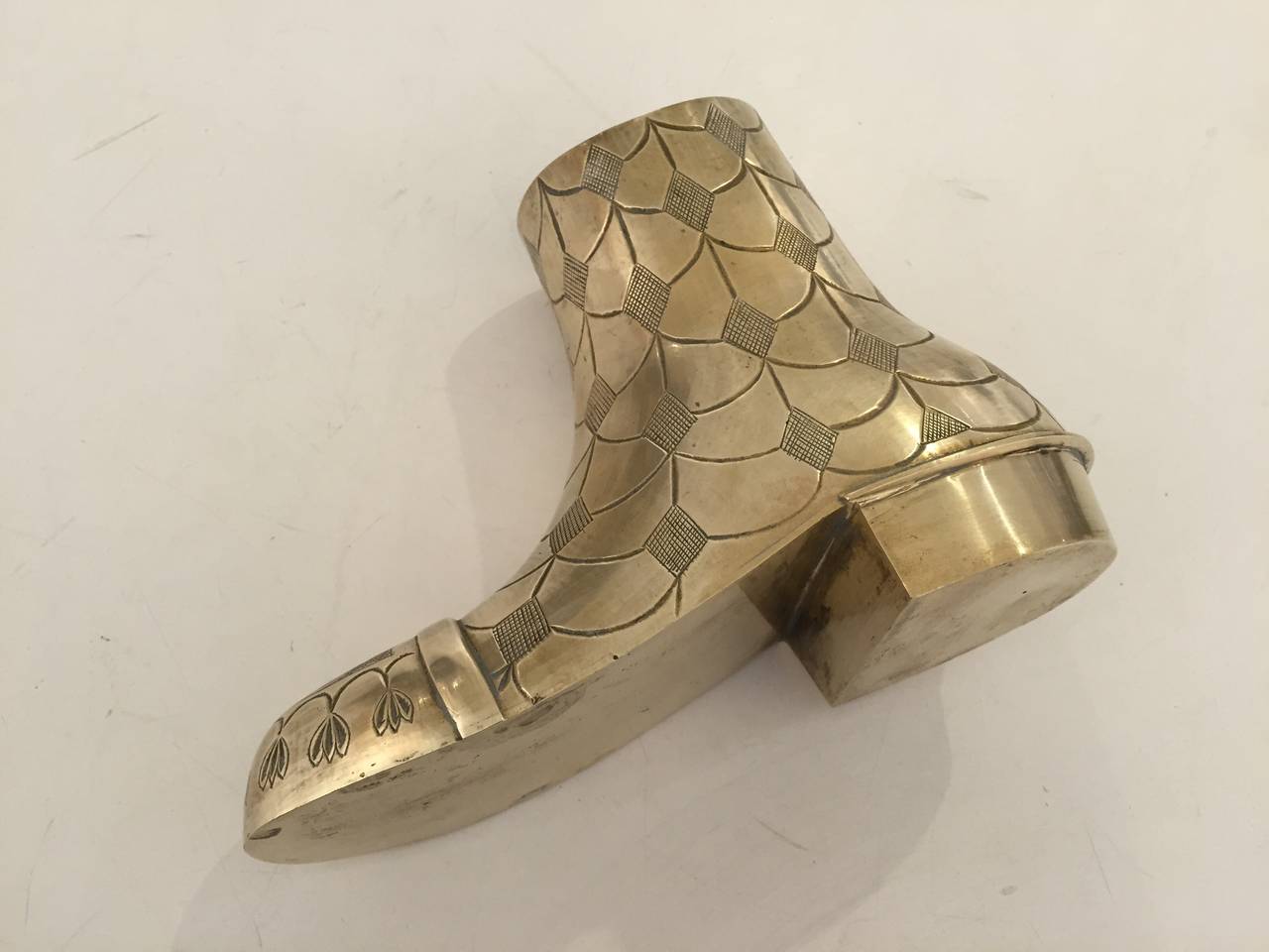 Cast and chased heavy brass vase in the shape of a boot. Indian, ca 1960.