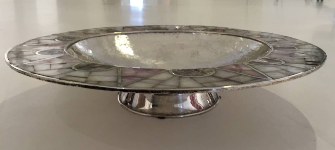 Circular hand-raised silver-plate bowl with a broad border of geometric abalone and mother-of-pearl inlay. Very good vintage condition - minor oxidation spots and plating wear. Signed on underside of rim. By Los Castillo, ca 1960.