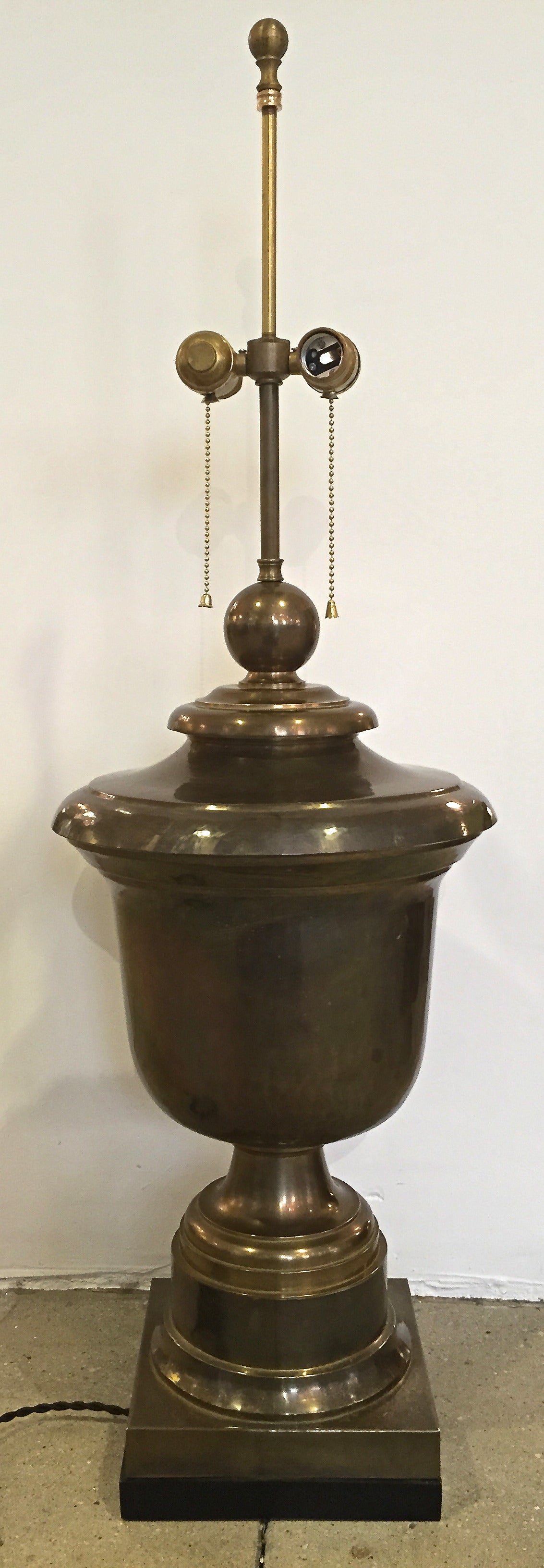 Large hand-forged brass urn with dark natural age patina mounted on a square black-painted wood base. Newly rewired, otherwise original. By Chapman, labeled and dated 1975.

Lamp body 25