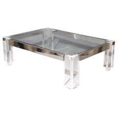 A rectangular lucite, chrome and glass cocktail table