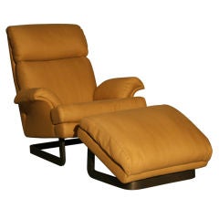 A comfortable modern chair and ottoman by Metropolitan