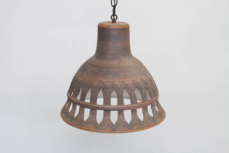 Littlejohn executed a series of hanging lights in her Big Bear workshop in the late 1970s. The five being offered for sale here are from her personal collection and are for sale for the first time.  Unglazed stoneware exterior, glazed interior. 