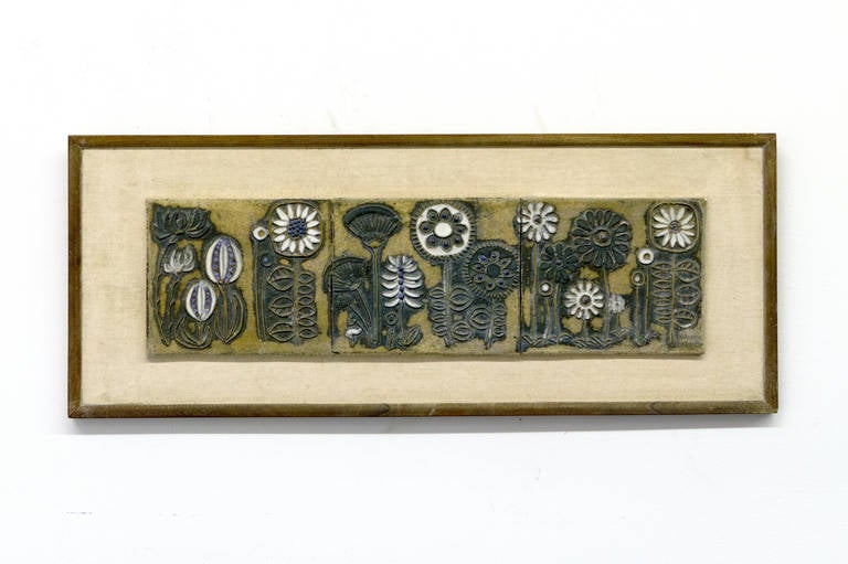Floral motif stoneware ceramic wall plaque by Victoria Littlejohn. Difficult to show in a photograph, two alternate lighting views are seen. Dimensions are including the frame. Unframed dimensions: 7