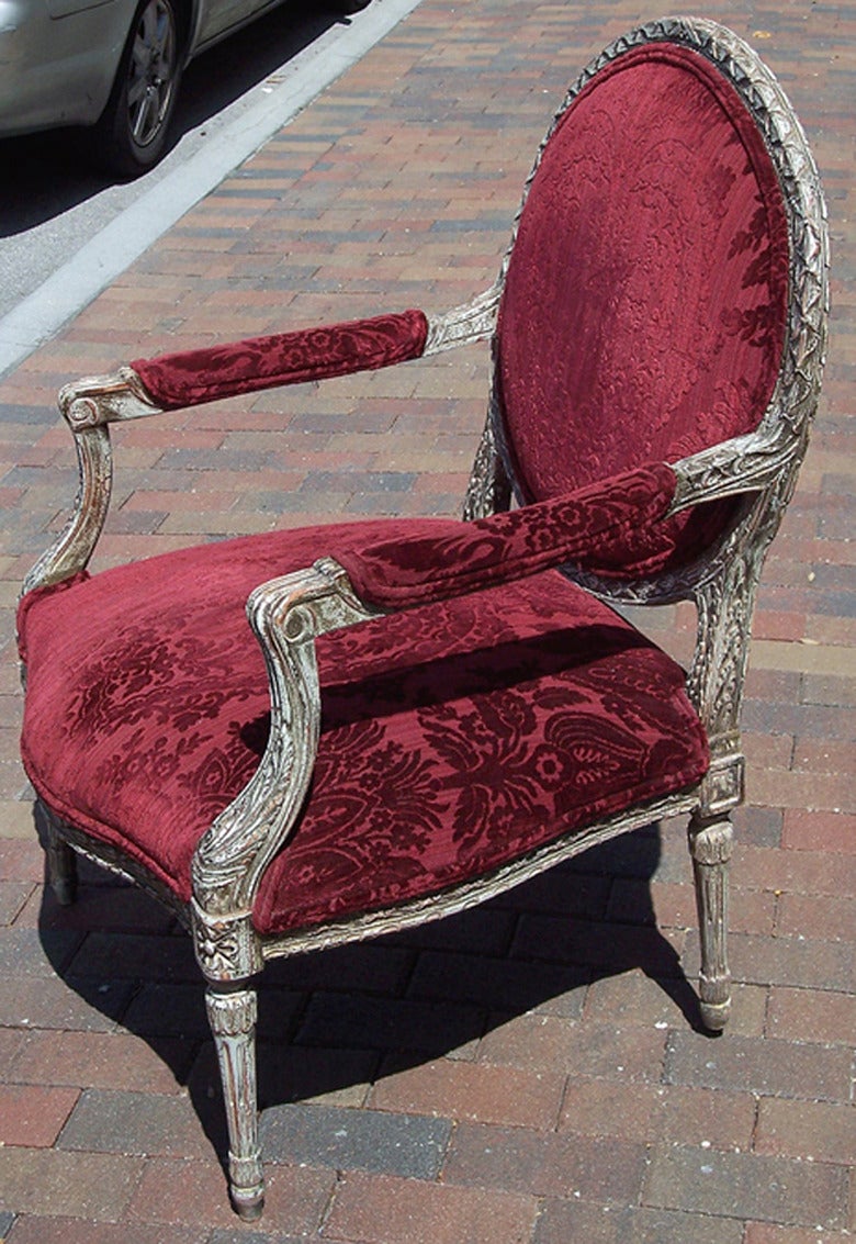 A pair of well carved patinated Louis XVI style armchairs.
