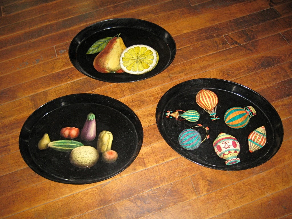 Piero Fornasetti metal trays, available with fruit, vegetable and balloon design (can be sold separately). Fornasetti was known for this type of metal design, which is silk-screened onto the surface and then varnished. Vivid colors against black!