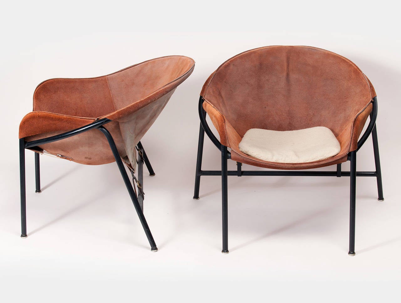 These suede and sheepskin easy chairs were designed by Erik Ole Jørgensen for Bovirke, Denmark. Painted metal bases with belted backs and loose cushions.